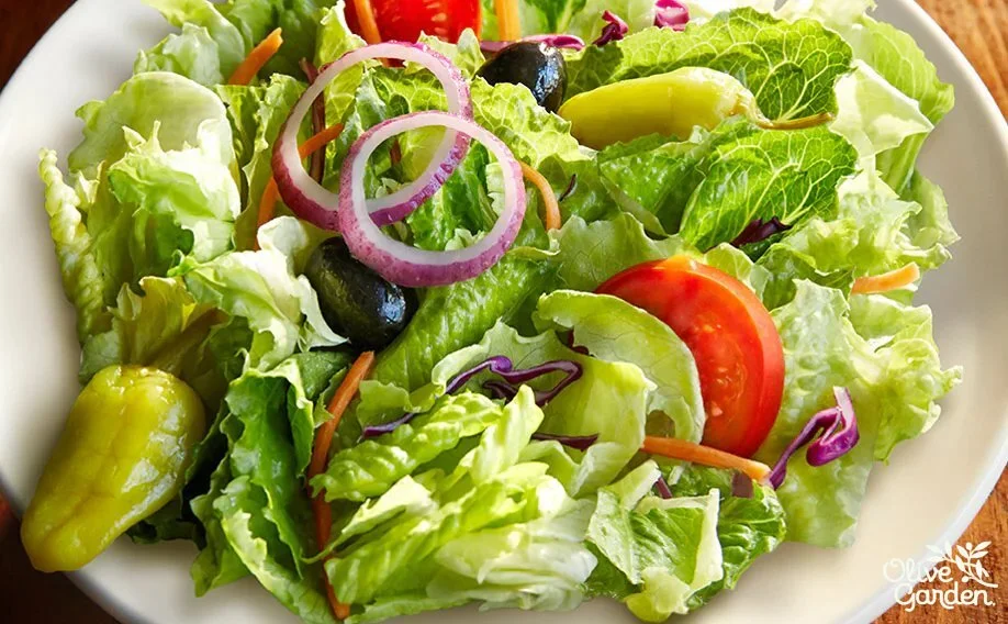 Famous House Salad without croutons with lettuce tomatoes and olives
